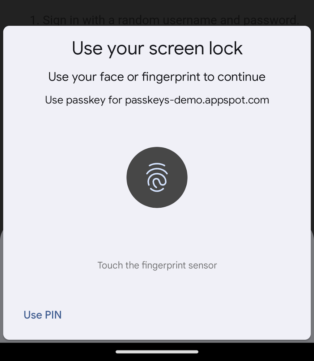 ภาพหน้าจอของกล่องโต้ตอบการยืนยันผู้ใช้ใน Chrome สำหรับ Android กล่องโต้ตอบจะแจ้งให้ผู้ใช้ยืนยันตัวตนโดยใช้การจดจำใบหน้าหรือการตรวจจับลายนิ้วมือ จากนั้นจะแสดงต้นทางที่ขอรับการตรวจสอบสิทธิ์ คุณจะเลือกยืนยันโดยใช้ PIN ได้ที่ด้านซ้ายล่าง